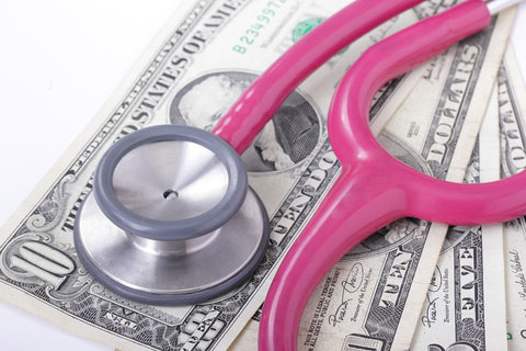 Picture of a stethoscope laying on top of money