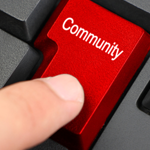 Person clicking keyboard that says "Community"