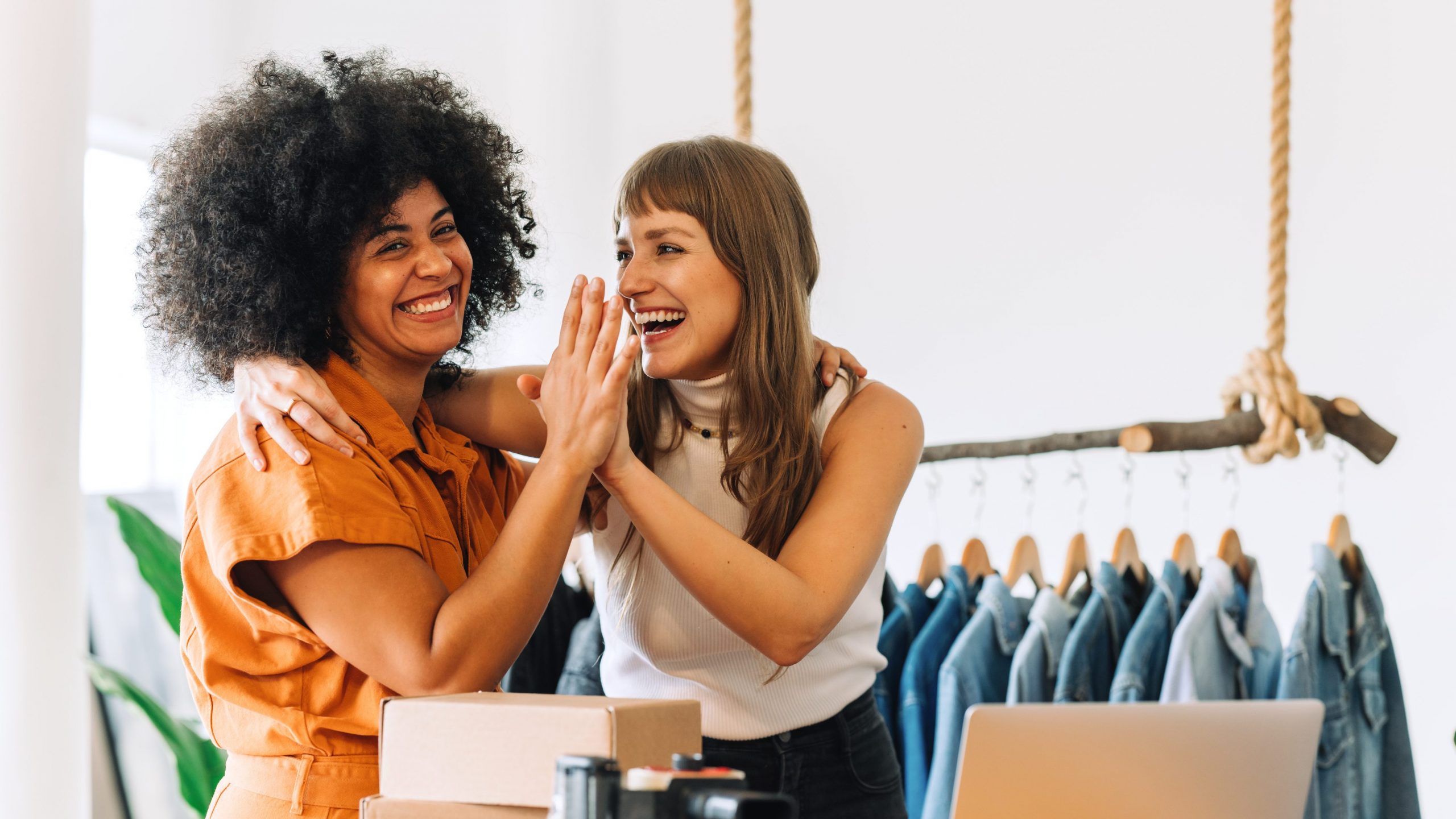 Two small business owners high-fiving
